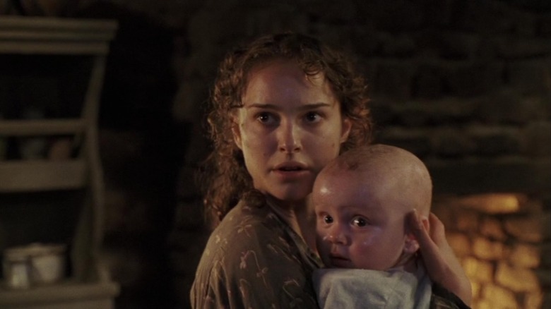 Portman clutching baby