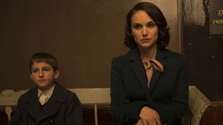 Portman and young son sitting on bench