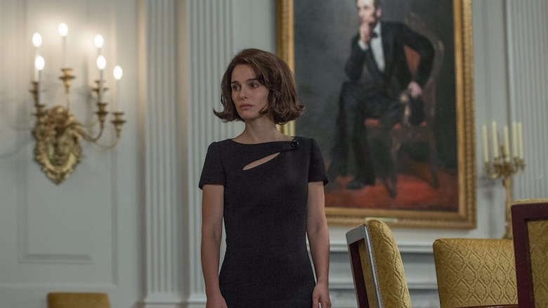 Jackie standing in black dress in the White House