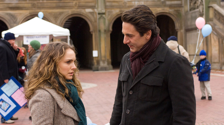 Portman and Scott Cohen standing in a town square