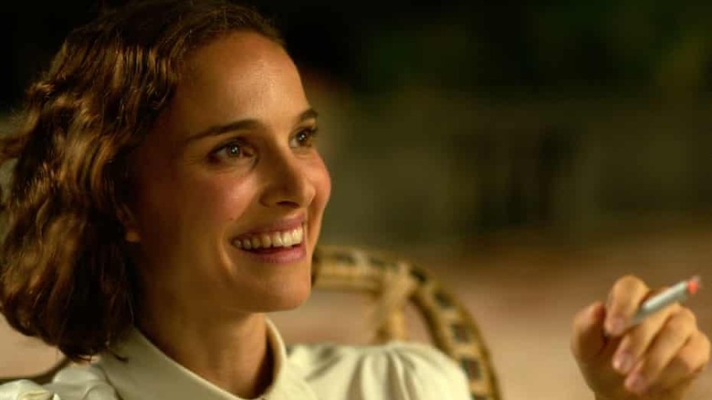 Portman smiling with a cigarette 