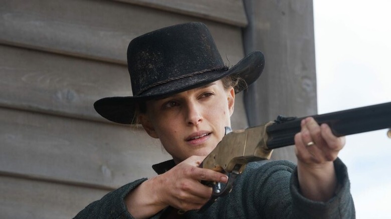 Portman aiming a shotgun 