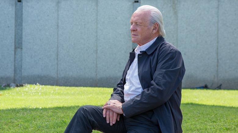 Anthony Hopkins sits on bench