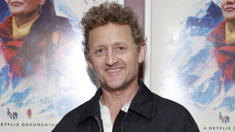 Alex Winter in front of movie posters