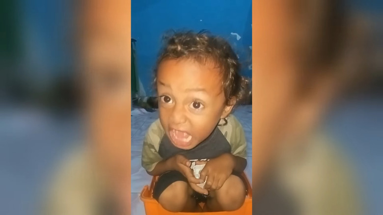 Kid screaming while sitting in container