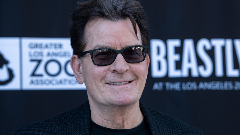 Charlie Sheen smiling in sunglasses