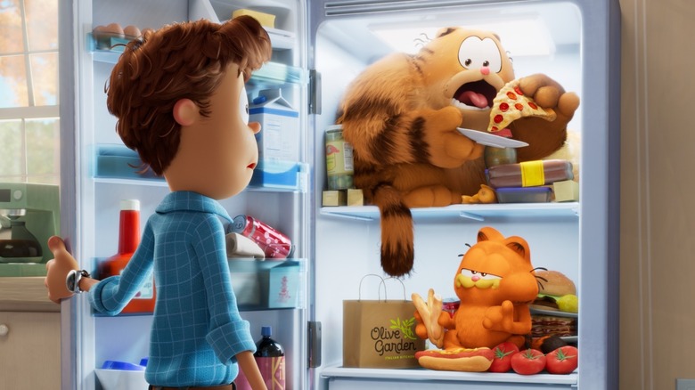 Jon opening fridge with cats inside