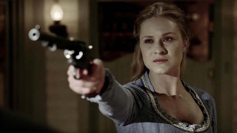 Dolores aiming a gun