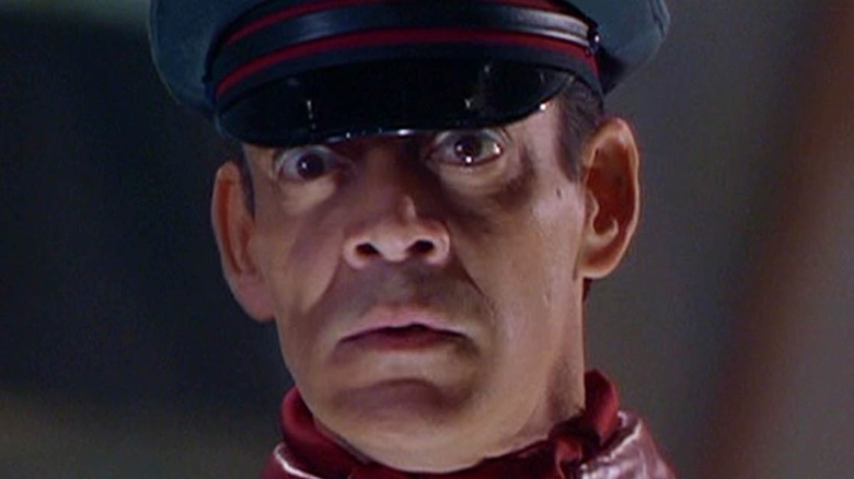 Raul Julia looking worried