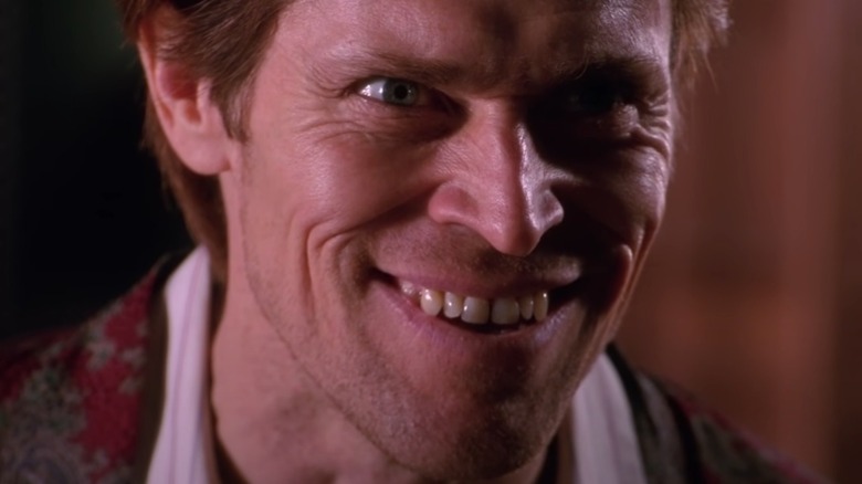 Willem Dafoe grins manaically