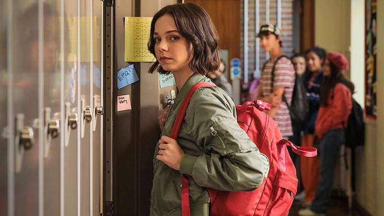 Pip standing near school lockers