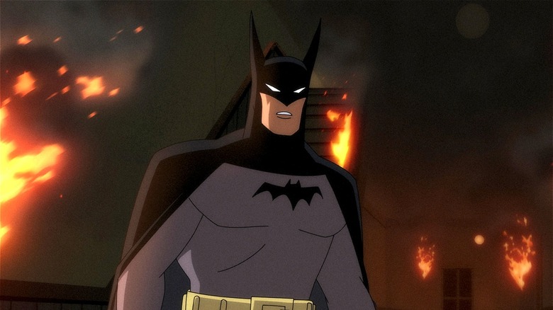 Batman standing by fire