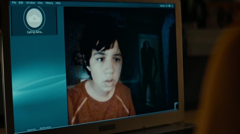 Grimcutty lurking behind a character, shown on laptop screen