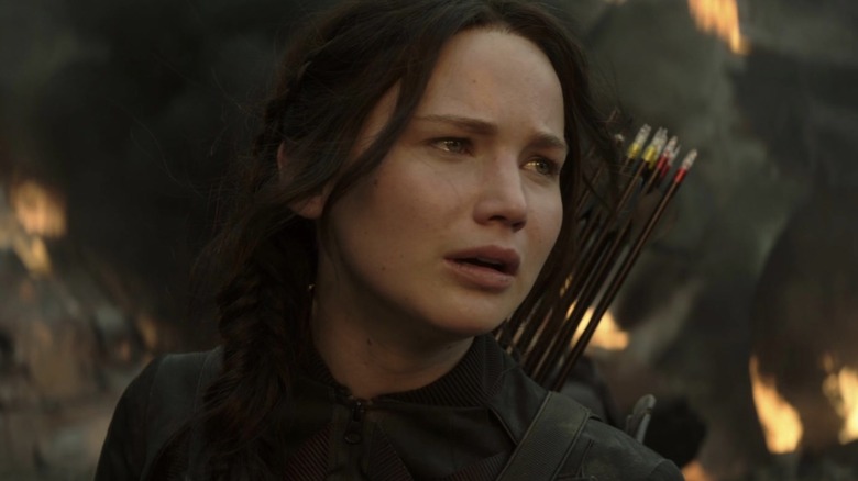 Katniss standing with burning rubble