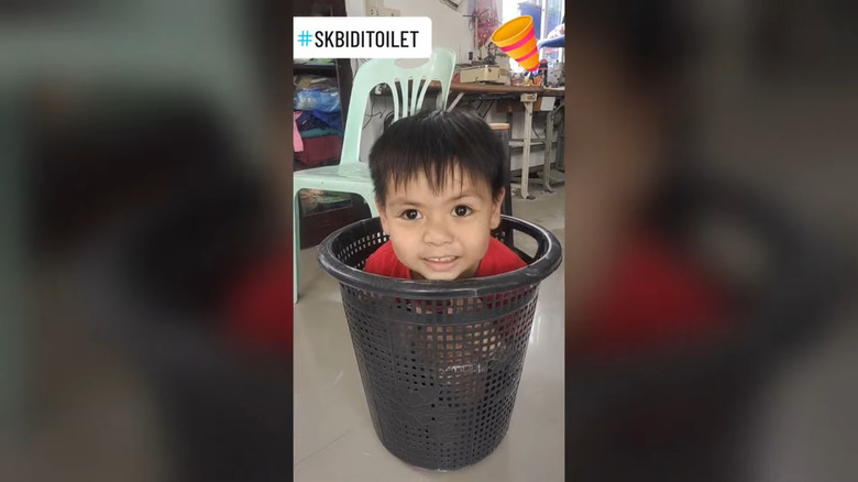 Young boy in clothes basket