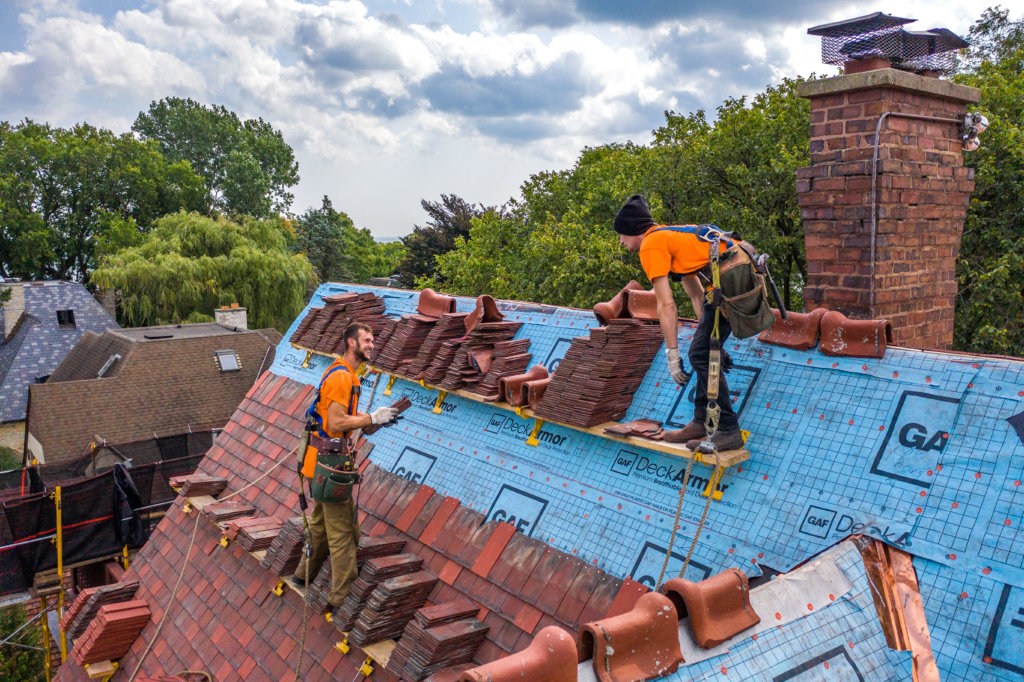  Roofers with fall protection being safe